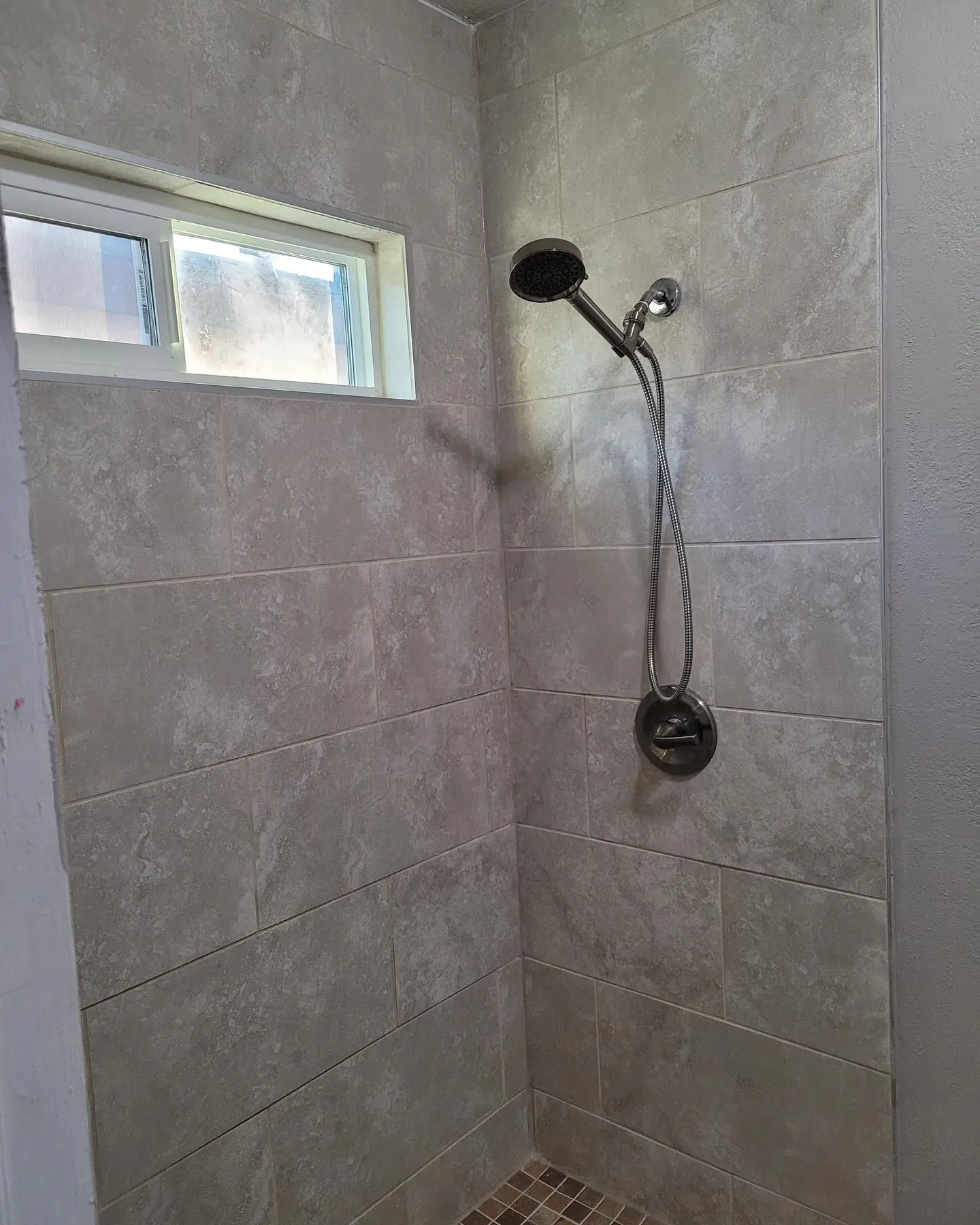 Bathroom tile renovation with updated shower tile by Mountain Ridge Renovations