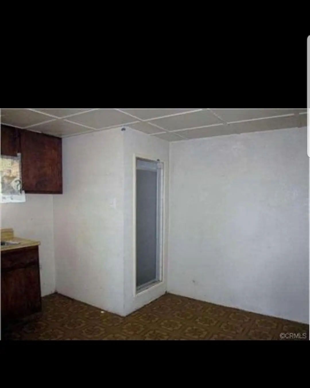 Dated guest house interior before renovation, with old flooring and finishes