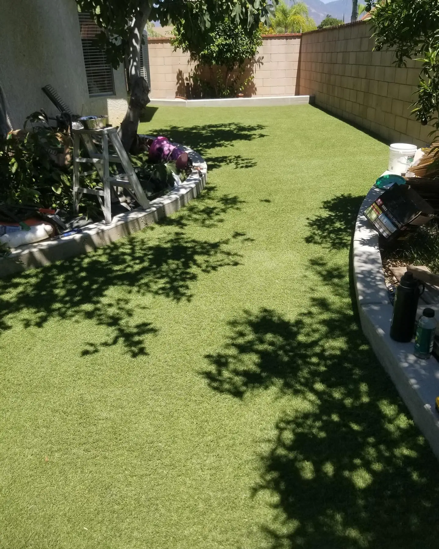 Artificial turf installation with a curved cement curb by Mountain Ridge Renovations near Parker, Colorado